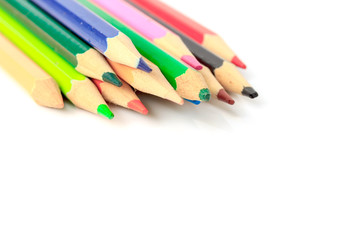 Colour pencils on white background close up