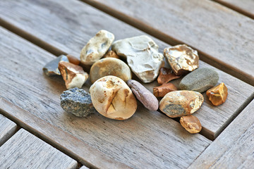 Lot of little rocks on wooden table