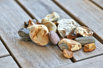 Lot of little rocks on wooden table