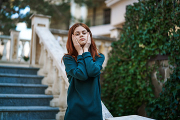 Young beautiful woman is walking along the street in the city