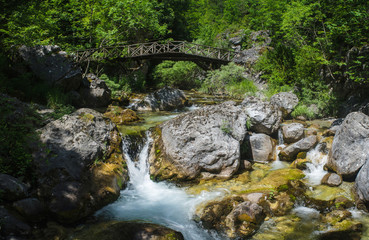Mountain river with a waterfall among the stonesю