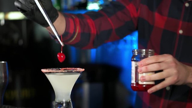 The barman makes a cool cocktail in a restaurant