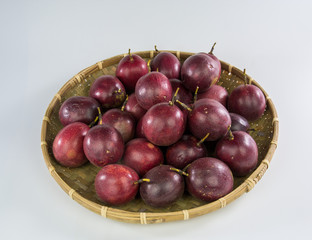 Passion fruit on bamboo basket isolated on white background
