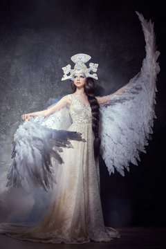 Art angel girl with wings fairy image. Swan Princess, Queen of angels. Lovely dress with wings. Studio beauty portrait