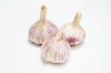 Three heads of garlic isolated on white
