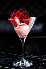 Scoop of the strawberry ice cream in martini glass