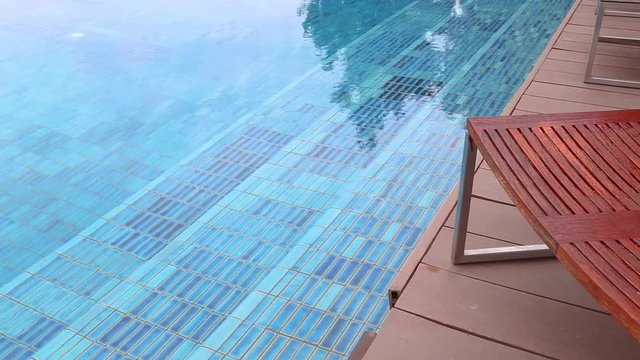 wooden teak Lounge Chairs, Patio Furniture, at Poolside with garden background