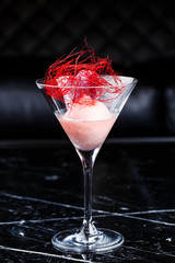 Scoop of the strawberry ice cream in martini glass