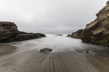 Rocky cove with motion blurred water at Leo Carrillo State Beach in Malibu, California.