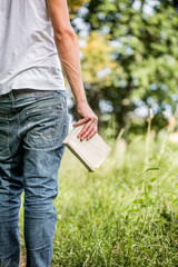 Naklejka premium a man holding a book in his hand