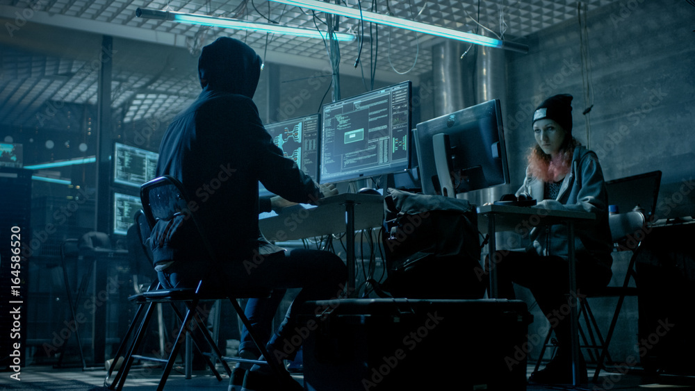 Poster group of teenage hackers organize attack on corporate data servers. their lair is dark and full of o