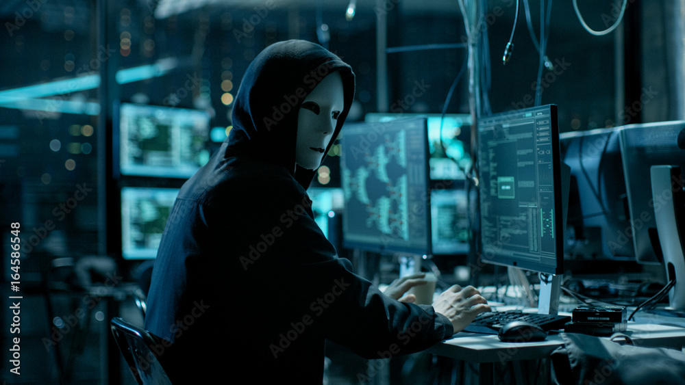 Aufkleber Masked Hacktivist Organizes Massive Data Breach Attack on Corporate Servers. He is in Underground Secret Location Surrounded by Displays and Cables.