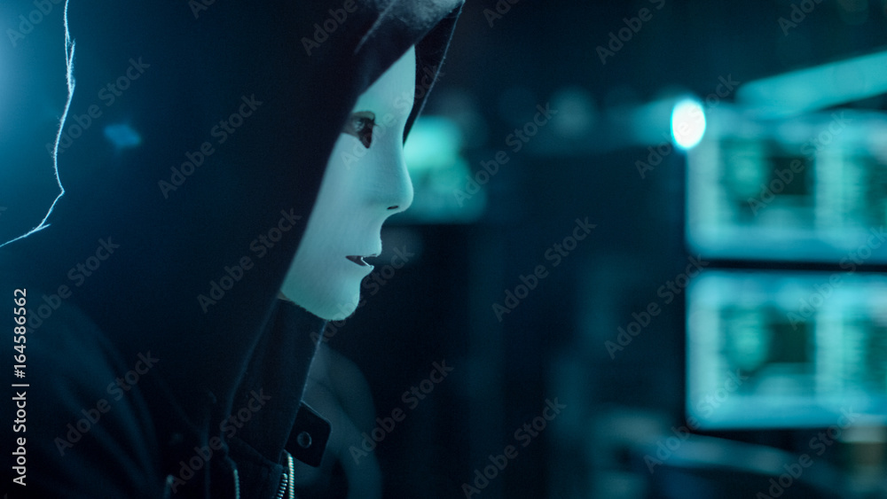 Aufkleber Close-up Shot of Masked Hacktivist Organizes malware Attack on Global Scale. He's in Underground Secret Location Surrounded by Displays and Cables.