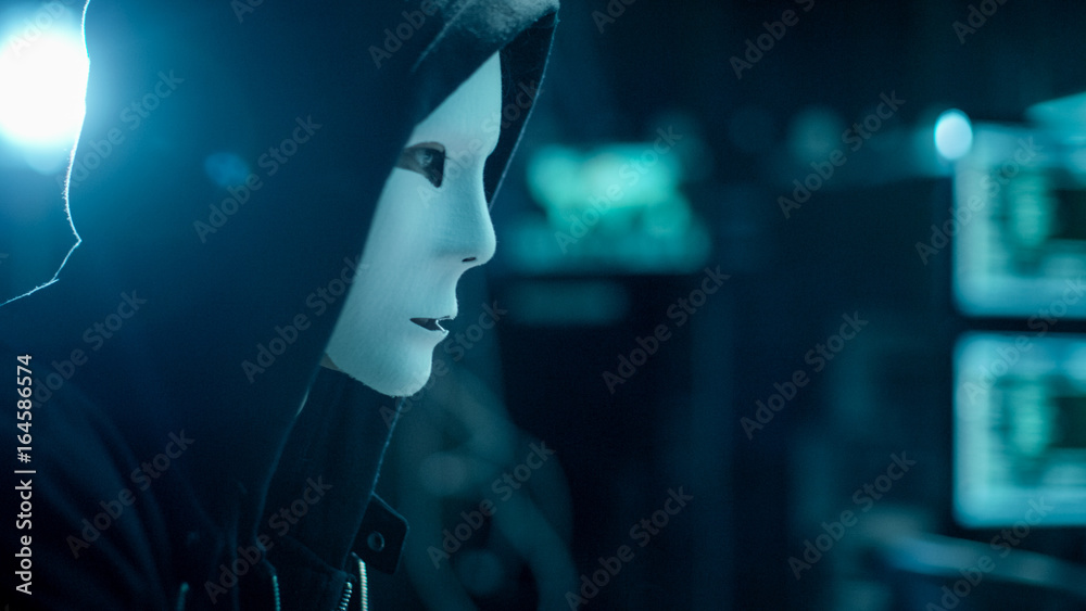 Aufkleber Close-up Shot of Masked Anonymous Hacker Organizes malware Attack on Global Scale. He is in Underground Secret Location Surrounded by Displays and Cables.