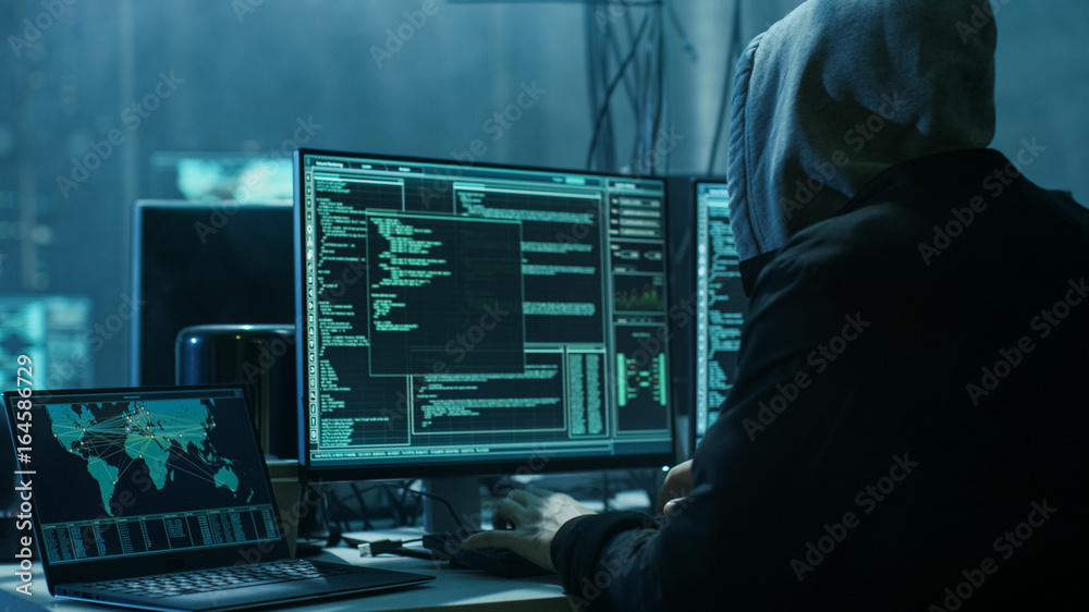 Poster Dangerous Hooded Hacker Breaks into Government Data Servers and Infects Their System with a Virus. His Hideout Place has Dark Atmosphere, Multiple Displays, Cables Everywhere.
