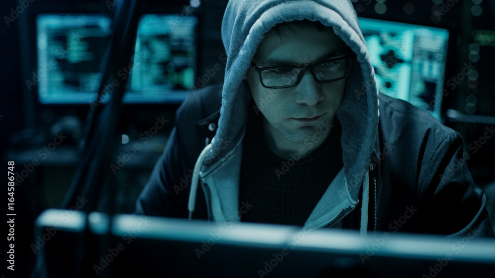 Aufkleber Dangerous Hooded Hacker Breaks into Government Data Servers and Infects Their System with a Virus. His Hideout Place has Dark Atmosphere, Multiple Displays, Cables Everywhere.