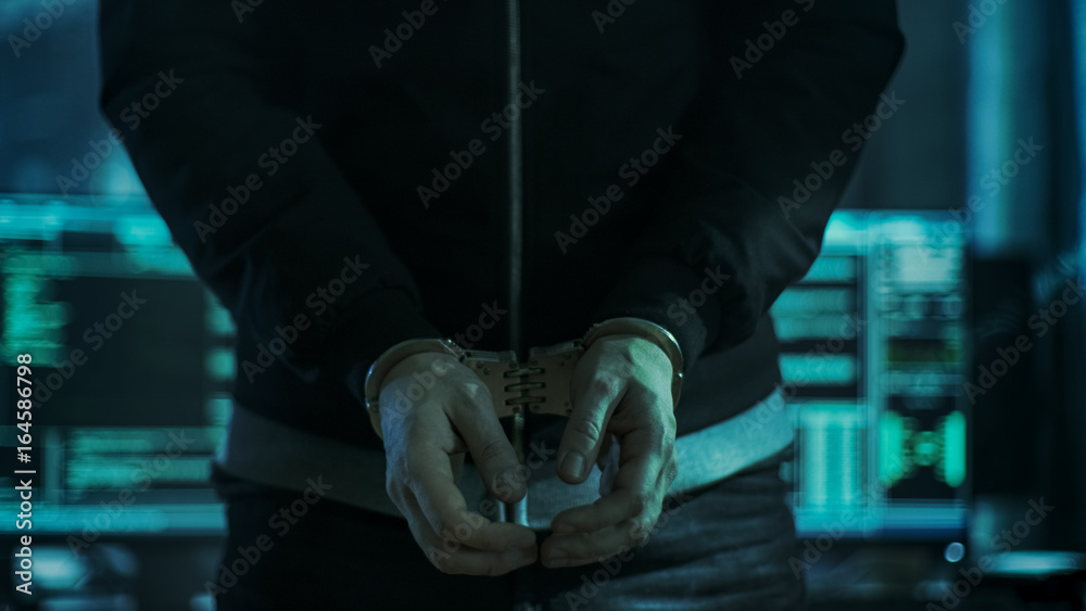 Aufkleber close-up of hacker getting handcuffed at his hidden place by cybersecurity police officer.