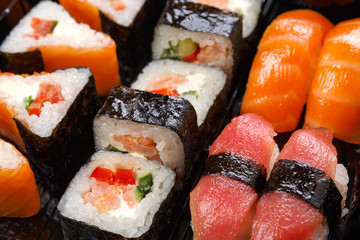 Set of sushi maki and rolls closeup in delivery box