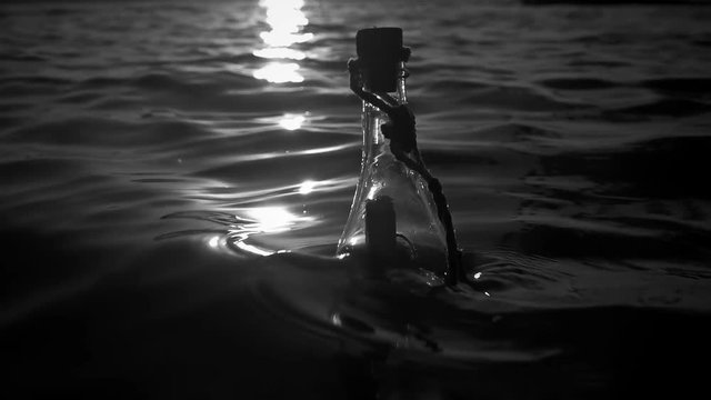 A bottle with a note swings on the waves