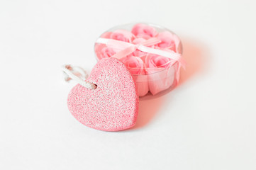 soap rose in gift box with bow and pumice in the shape of a heart on a white background