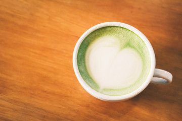 Green tea cup in cafe shop time to relaxing ,hipster tone and soft of focus