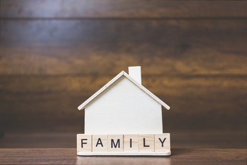 Obraz na płótnie Canvas House model with Family word on wooden blocks.