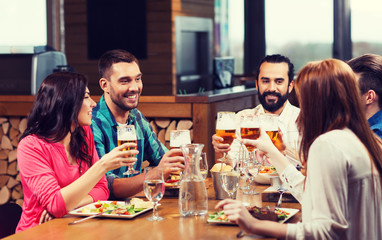 friends dining and drinking beer at restaurant