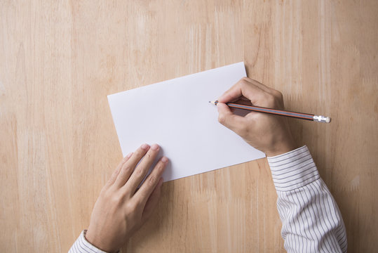 Business Hand Writing Note Paper On Wood Table Office.Top View With Copy Space For Input The Text.