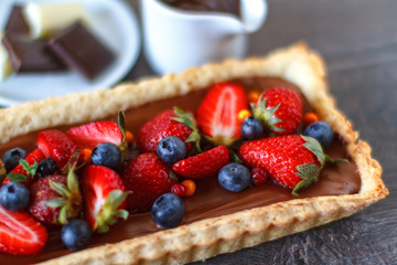 Tart with strawberries, blueberries and chocolate