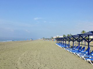 A lot of plastic chaise-lounge on the beach