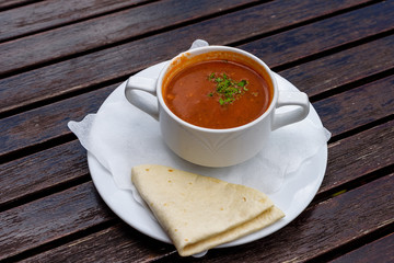 Cioppino soup in white cup with tortillas. Authentic mexican food. Top view