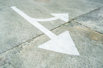 Arrow on the road and white colour