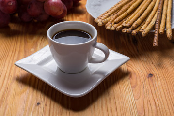 Cup of coffee in porcelain cup on wood table