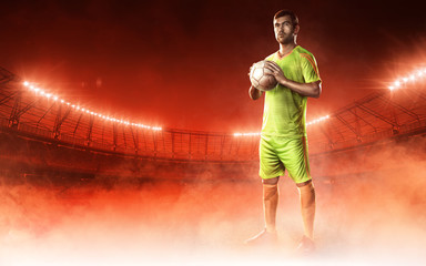 soccer player on a field holding a ball on a red steam background © TandemBranding