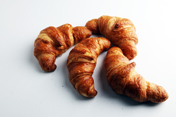 freshly baked croissants on white board, bakery concept