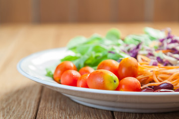 Healthy concept with mixed fruits and vegetables on wooden background