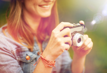 close up of woman with camera shooting outdoors
