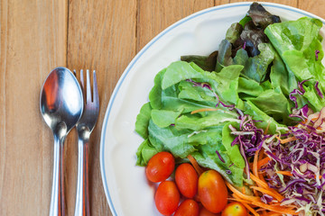 Healthy concept with mixed fruits and vegetables on wooden background