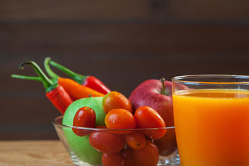 Healthy concept with mixed fruits and vegetables on wooden background