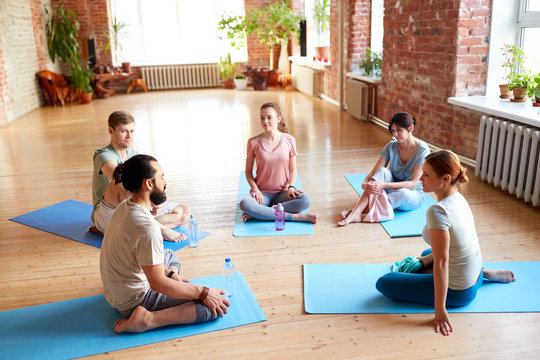 group of people resting on yoga mats at studio