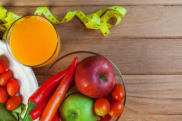 Healthy concept with mixed fruits and vegetables on wooden background