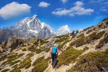 Naklejka na ściany i meble Goup of climbers in action, view on the Himalayas peak Cholatse, Nepal