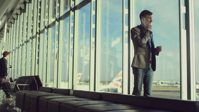 Young Businessman Is Talking Over His Iphone In Airport