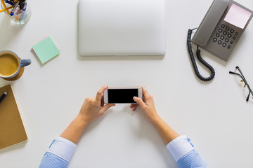 businesswoman with smartphone working at office