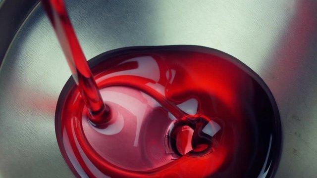 Closeup of Motor oil pouring into a funnel

