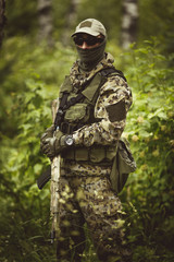 Military man in camouflage , helmet