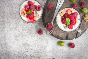 natural healthy dessert or breakfast with natural yoghurt in a glass mug and ripe berries