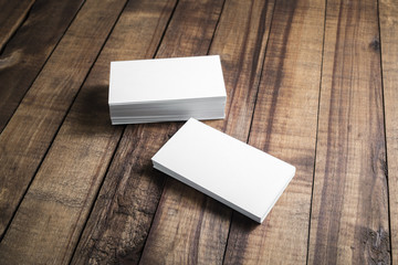 Photo of blank business cards on wood table background. Template for ID.