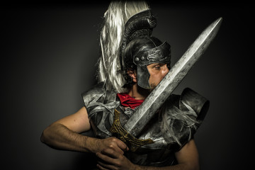 Legionnaire, Roman centurion with armor and helmet with white chalk, steel sword and long red cape