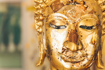 Golden Buddha statue in Buddhist temple or wat, is public domain or treasure of Buddhism.